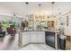 Open kitchen featuring a central island, hardwood floors, and stainless steel appliances at 18223 Nestlebranch Ct, Hudson, FL 34667