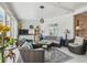 Inviting sunroom featuring tile floor, and comfortable wicker furniture at 18223 Nestlebranch Ct, Hudson, FL 34667