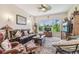 Inviting living room with large window overlooking the golf course and comfortable seating area at 18223 Nestlebranch Ct, Hudson, FL 34667