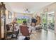 Bright living room with golf course view, comfortable seating, and access to the outdoor lanai at 18223 Nestlebranch Ct, Hudson, FL 34667