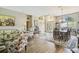 Open-concept living space blending the living and dining areas, with hardwood floors and neutral tones at 18223 Nestlebranch Ct, Hudson, FL 34667