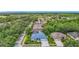 An aerial view of a neighborhood featuring a single-story home with mature trees and landscaping at 18902 Saint Laurent Dr, Lutz, FL 33558