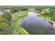Scenic aerial view of a lush green golf course, serene lake, and surrounding residential area at 18902 Saint Laurent Dr, Lutz, FL 33558