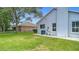 Spacious backyard with mature trees, privacy hedges, and a screened-in pool enclosure at 18902 Saint Laurent Dr, Lutz, FL 33558