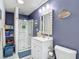 Charming bathroom with a glass-enclosed shower, white vanity, and beach-themed decor for a coastal feel at 18902 Saint Laurent Dr, Lutz, FL 33558