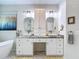 Bright bathroom with double vanity, vessel sinks, granite countertops, and decorative mirrors and lighting fixtures at 18902 Saint Laurent Dr, Lutz, FL 33558