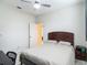 Cozy bedroom featuring a ceiling fan and a view to a closet, perfect for a peaceful retreat at 18902 Saint Laurent Dr, Lutz, FL 33558
