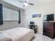 Bedroom with neutral walls, window, ceiling fan, and simple furnishings at 18902 Saint Laurent Dr, Lutz, FL 33558