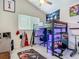 This bedroom has a bunk bed with a desk and workout space underneath and a football theme at 18902 Saint Laurent Dr, Lutz, FL 33558