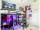 This bedroom has a bunk bed with a desk and workout space underneath and a sports theme at 18902 Saint Laurent Dr, Lutz, FL 33558