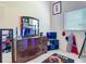 This bedroom has a dresser with a sports theme bunk bed reflected in the mirror at 18902 Saint Laurent Dr, Lutz, FL 33558