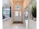 Welcoming entryway with decorative glass front door, transom window, and open view to living spaces at 18902 Saint Laurent Dr, Lutz, FL 33558