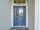 Elegant front door with decorative glass and security camera, providing style and safety at 18902 Saint Laurent Dr, Lutz, FL 33558