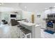 Open-concept kitchen featuring a breakfast bar, stainless steel appliances, and seamless flow to the living area at 18902 Saint Laurent Dr, Lutz, FL 33558