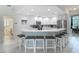 Open kitchen with island seating, stainless appliances, and white cabinets is ideal for entertaining at 18902 Saint Laurent Dr, Lutz, FL 33558