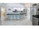 Kitchen boasts a central island with seating, stainless appliances, and neutral color palette at 18902 Saint Laurent Dr, Lutz, FL 33558