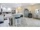 Spacious kitchen includes island with seating, stainless appliances and light, bright neutral colors at 18902 Saint Laurent Dr, Lutz, FL 33558