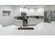 Spacious kitchen featuring white cabinets, stainless steel appliances, and a modern sink with a stylish faucet at 18902 Saint Laurent Dr, Lutz, FL 33558