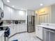 Bright kitchen features white cabinets, stainless appliances, and tiled backsplash and flooring at 18902 Saint Laurent Dr, Lutz, FL 33558