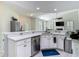 Bright, open kitchen with a breakfast bar, stainless steel appliances, and seamless access to the adjacent living space at 18902 Saint Laurent Dr, Lutz, FL 33558