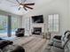 Vaulted ceilings and fireplace highlight the living room which opens onto the pool and patio at 18902 Saint Laurent Dr, Lutz, FL 33558