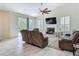 Comfortable living room offers a fireplace, ceiling fan and view of the pool and patio at 18902 Saint Laurent Dr, Lutz, FL 33558