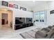 Open-concept living room with high ceilings, two televisions, and a comfortable reclining sofa at 18902 Saint Laurent Dr, Lutz, FL 33558