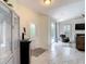 Cozy living room with vaulted ceilings, fireplace, and sliding glass doors to the pool area at 18902 Saint Laurent Dr, Lutz, FL 33558