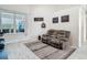 Inviting living room featuring a cozy, oversized reclining sofa and large window for natural light at 18902 Saint Laurent Dr, Lutz, FL 33558