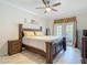 Comfortable bedroom featuring natural light, and tile floors at 18902 Saint Laurent Dr, Lutz, FL 33558