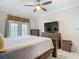 Relaxing bedroom space featuring a ceiling fan, bed, and closet at 18902 Saint Laurent Dr, Lutz, FL 33558