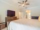 Spacious bedroom with a wooden dresser and view of an en suite bathroom at 18902 Saint Laurent Dr, Lutz, FL 33558