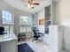 Bright office with a ceiling fan, arched windows with plantation shutters, and custom built-ins at 18902 Saint Laurent Dr, Lutz, FL 33558