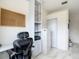 Bright home office with an ergonomic chair, built-in shelving, and corkboard, providing a functional workspace at 18902 Saint Laurent Dr, Lutz, FL 33558