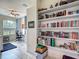 Bright office space with view of the doorway to another room, filled bookshelf at 18902 Saint Laurent Dr, Lutz, FL 33558