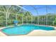 Beautiful screened pool and spa surrounded by lush landscaping, creating a private oasis at 18902 Saint Laurent Dr, Lutz, FL 33558