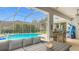 Covered patio with outdoor kitchen, dining, and swimming pool access, perfect for entertaining at 18902 Saint Laurent Dr, Lutz, FL 33558