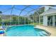 Sparkling in-ground pool with a screened enclosure offers a relaxing and private retreat at 18902 Saint Laurent Dr, Lutz, FL 33558