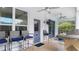 Inviting pool patio featuring stylish bar seating, a built-in grill, and comfortable outdoor seating, ideal for entertaining at 18902 Saint Laurent Dr, Lutz, FL 33558