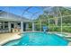 Inviting screened-in pool with spa and outdoor bar area, perfect for enjoying the outdoors at 18902 Saint Laurent Dr, Lutz, FL 33558
