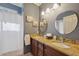 Bathroom features granite counters, double sinks, and large mirrors at 19418 Morden Blush Dr, Lutz, FL 33558