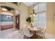 Bright dining area with a round table, chandelier, and large windows at 19418 Morden Blush Dr, Lutz, FL 33558