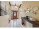 Bright foyer featuring tiled flooring, a decorative table, and arched doorways providing an inviting and elegant entrance at 19418 Morden Blush Dr, Lutz, FL 33558