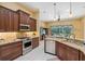 Kitchen features stainless appliances, granite counters, and dark wood cabinetry at 19418 Morden Blush Dr, Lutz, FL 33558