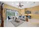 Bright and airy living room boasts tile floors, a stylish wet bar, comfortable seating, and seamless access to the pool at 19418 Morden Blush Dr, Lutz, FL 33558