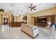 Open-concept living space offers tile flooring, coffered ceilings, and seamless flow to the kitchen and dining areas at 19418 Morden Blush Dr, Lutz, FL 33558
