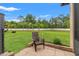 View of the lush, expansive backyard with manicured lawn, patio, and privacy fence, ideal for outdoor activities at 1987 Trillium Blvd, Brooksville, FL 34604
