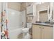 Neat bathroom with a combination bathtub and shower, toilet, vanity with storage, and granite countertops at 1987 Trillium Blvd, Brooksville, FL 34604