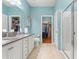 Bathroom features a double vanity, toilet, walk-in closet, and glass enclosed shower at 1987 Trillium Blvd, Brooksville, FL 34604