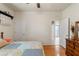 Bedroom featuring hardwood floors, neutral walls, and a view of the en suite bathroom at 1987 Trillium Blvd, Brooksville, FL 34604